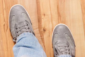 Gray shoes for men on rustic board, male footwear concept