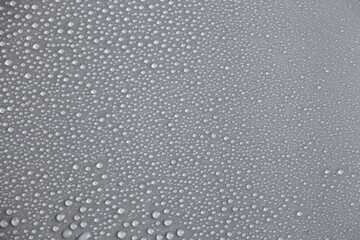 Water drops on light background, top view, close-up, macro. Great background with natural water drops and natural light