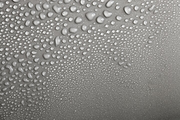 Water drops on light background, top view, close-up, macro. Great background with natural water drops and natural light