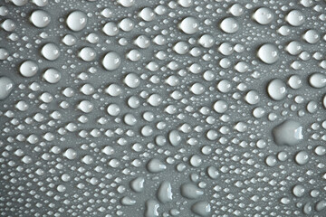 Water drops on light background, top view, close-up, macro. Great background with natural water drops and natural light