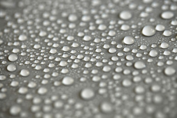 Water drops on light background, top view, close-up, macro. Great background with natural water drops and natural light