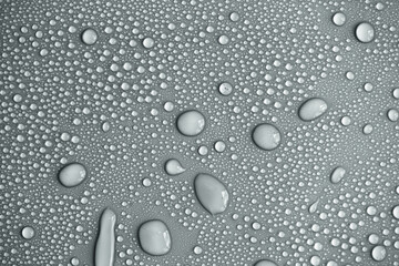 Water drops on light background, top view, close-up, macro. Great background with natural water drops and natural light