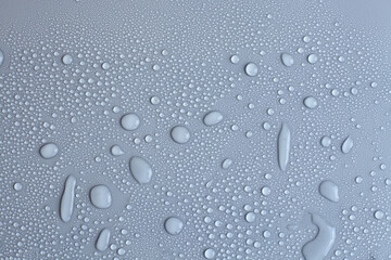 Water drops on light background, top view, close-up, macro. Great background with natural water drops and natural light