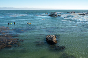 Fototapeta premium Kayaking along rocky shore, Pismo Beach, California coastline
