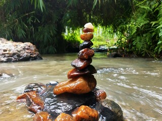 Stones remain as water flows away in a stream in Wayanad, Kerala, God's own Country.
