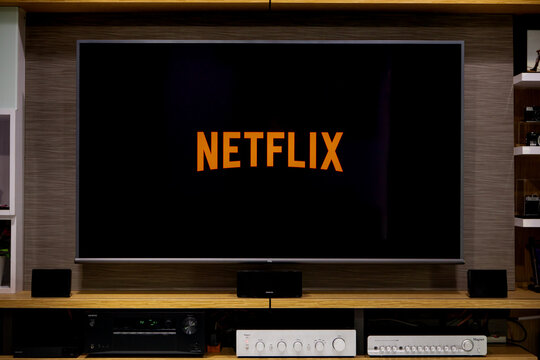 BANGKOK, THAILAND - AUGUST 3rd, 2020 : Netflix app logo displayed on TCL TV screen in living room of modern home. Netflix is one of the most popular paid entertainment and movie services in Thailand