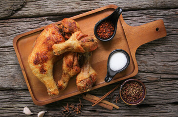 Chicken Drumstick on wooden board.