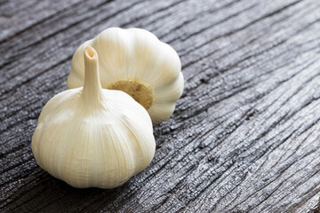 Raw Garlic bulbs on dark wooden background..