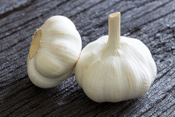 Raw Garlic bulbs on dark wooden background..