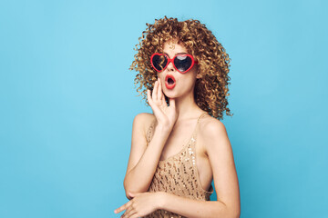 Impulsive girl hand gestures on an isolated background, red sunglasses 