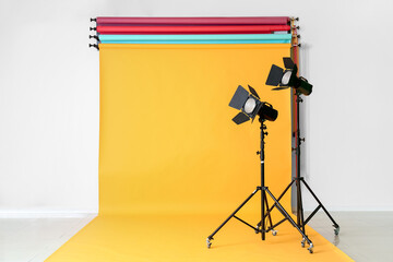 Color backdrops and modern equipment in photo studio