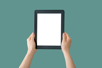 Hands with modern tablet computer on color background