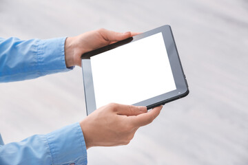 Woman with modern tablet computer at home