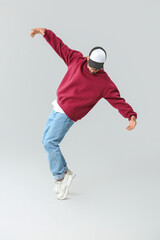 Fototapeta na wymiar Male hip-hop dancer on grey background