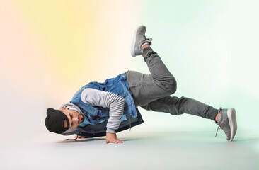 Male hip-hop dancer on color background