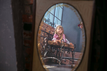 Fototapeta na wymiar Little cute girl background vintage and old mirror