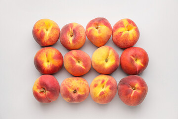 Many ripe peaches on light background