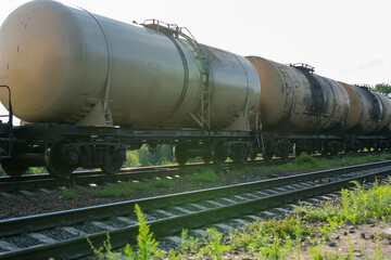 Fototapeta na wymiar Old barrels of oil on the railway.