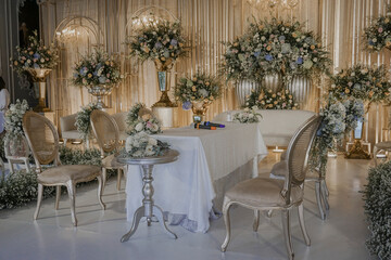 Fototapeta na wymiar wedding stage decoration with fabric and flower bouquet. flower decoration on wedding backdrop