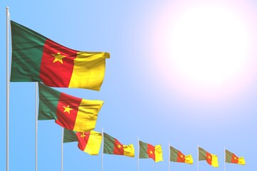 cute many Cameroon flags placed diagonal on blue sky with space for text - any celebration flag 3d illustration..