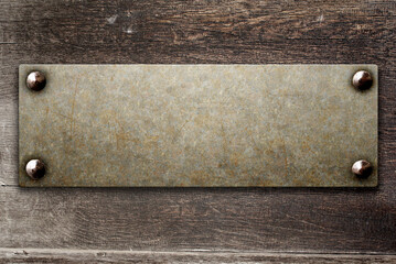 Grunge background with metallic plate on wood board