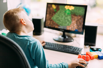 Little Caucasian Boy Playing In Computer Games