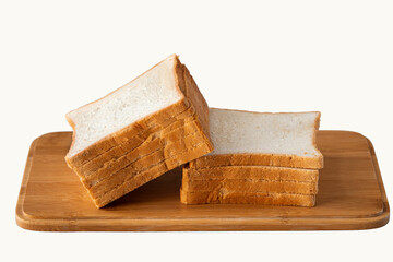 Sliced toast bread on a cutting board on light grey background