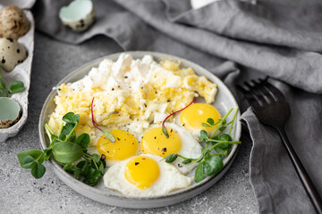 scrambled eggs and quail egg omelet with greens