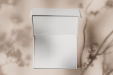 White open empty cardboard box on a light beige background with shadows. The concept of packing a gift, cosmetics, order. Top view. Mock up. 3d rendering