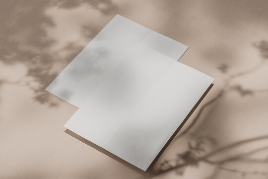 Two sheets of A4 paper lying on top of each other on a light beige background with shadows. Side view. Mock up. 3d rendering