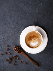 A cup of coffee with coffee beans in the background