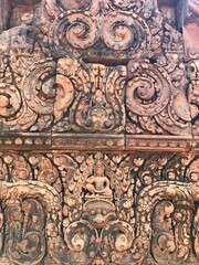 Fototapeta na wymiar Historic Site in Cambodia, Citadel of the women, the pink color of the limestone and the elaborate decorative carvings of many female deities that grace its walls. 