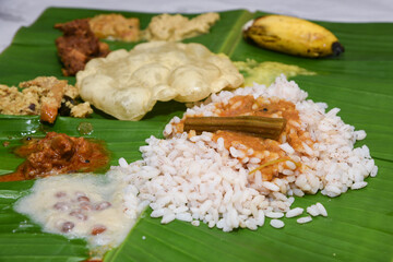 Kerala Onam sadhya, boiled rice with many curries Parippu, Sambar, dessert Payasam on banana leaf ....