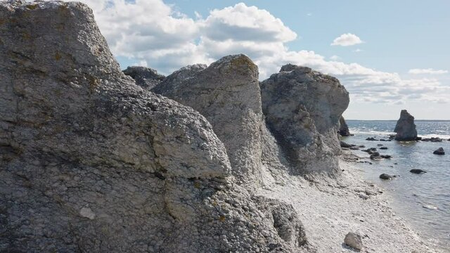 Rauk column-like landform in Gotland, Sweden, on sunny day, pan right