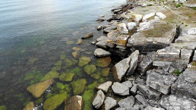 Drone flying over rocky coastline of Asunden Raukfield, birds eye view