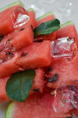 Fresh watermelon sliced into pieces on white background