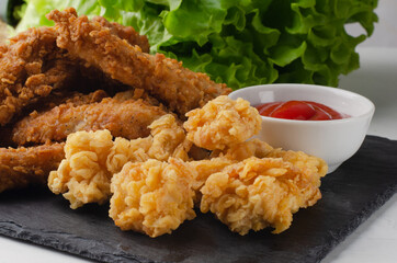 Fried chicken with french fries and nuggets.