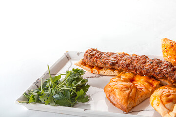 adana kebab. Turkish Adana Kebab with Vegetables on the Plate. Meat kebab with green salad leaves