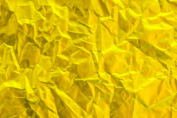 Gold foil texture background, pattern of yellow wrapping paper with crumpled and wavy.
