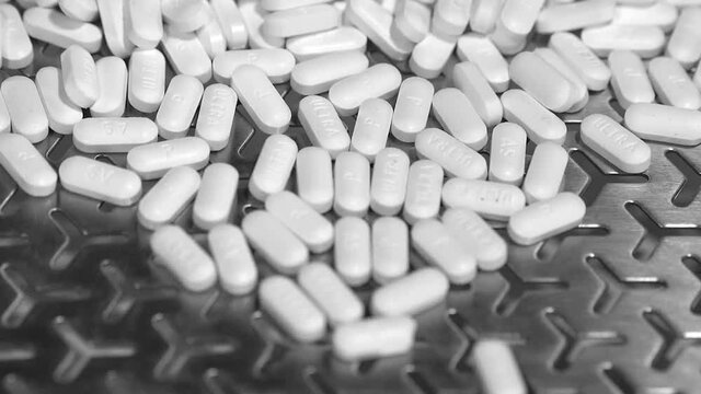 Cinematic footage of Pills, tablets and caplets on a production plant