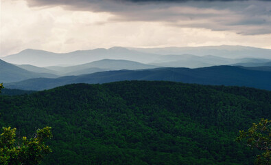 Rain over forest mountains. Misty mountain landscape hills at rainy day.