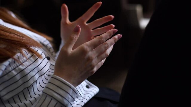 Close-up of unrecognizable young woman moving and gesturing hands during meeting. Lady nervously moving hands during meeting with psychologist while sitting on couch in office. Shooting in slow motion