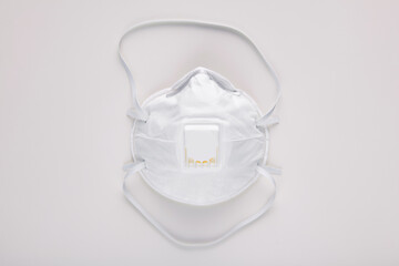 Medical reusable respirator mask on white background, top view. Concept prevention of respiratory diseases and pneumonia due to new coronavirus. Corona virus outbreaking.