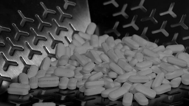 Cinematic footage of Pills, tablets and caplets on a production plant