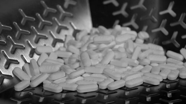 Cinematic footage of Pills, tablets and caplets on a production plant