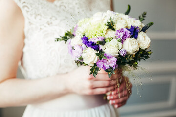 Obraz na płótnie Canvas Wedding bouquet of the bride in women's hands. wedding flowers. Bridal bouquet of fresh flowers, wedding concept