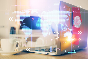 Double exposure of desktop with computer and world map hologram. International data network concept.