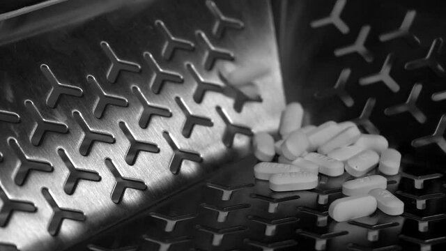 Cinematic footage of Pills, tablets and caplets on a production plant