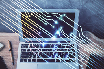 Double exposure of desktop computer and technology theme hologram. Concept of software development.