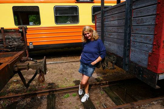 Vastervik, Sweden A woman poses amidst freight cars at the train station.